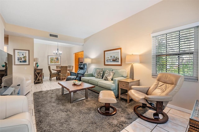 tiled living room featuring a notable chandelier