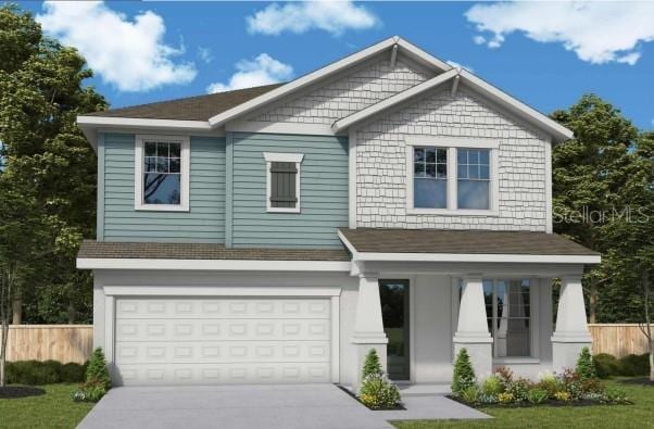 craftsman inspired home featuring a garage, concrete driveway, and fence