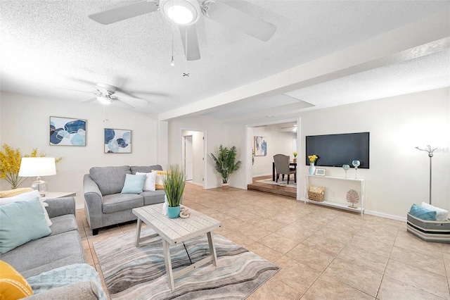 living room with ceiling fan, a textured ceiling, and light tile patterned floors