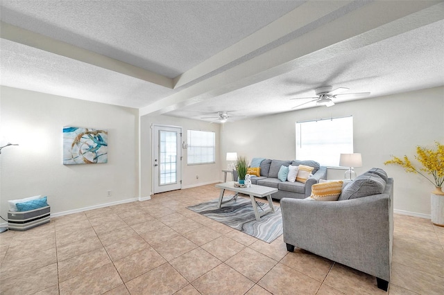 living room with ceiling fan, a textured ceiling, and light tile patterned floors