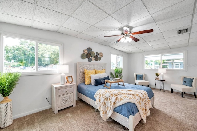 bedroom featuring carpet flooring and a drop ceiling