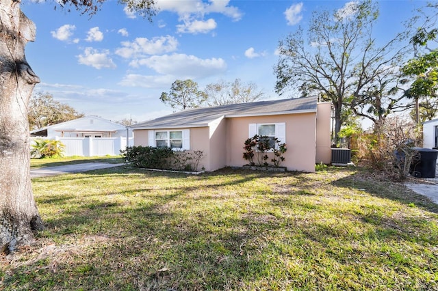 view of front of property featuring cooling unit and a front lawn