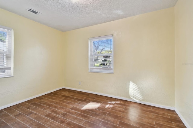 spare room with a textured ceiling