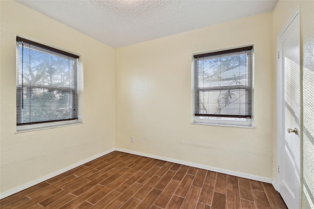 spare room with a textured ceiling