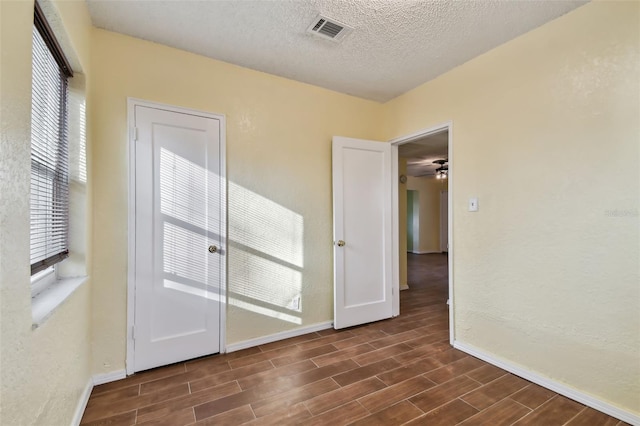 unfurnished room featuring a textured ceiling