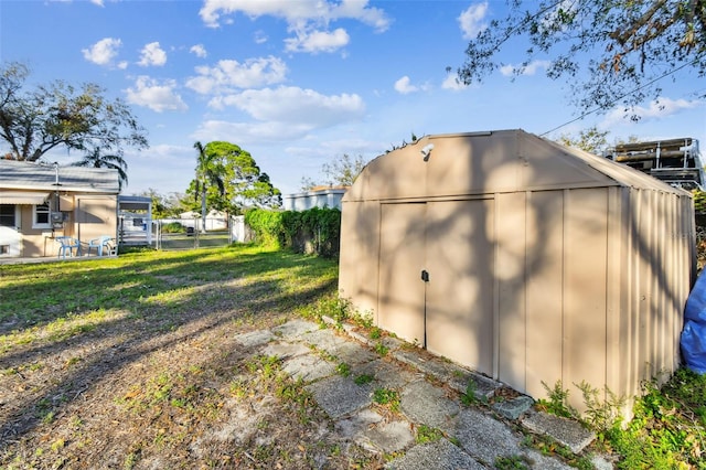 view of outbuilding featuring a lawn