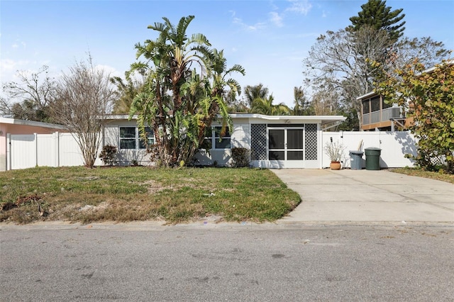 view of front of property with a carport and a front lawn