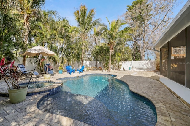 view of swimming pool featuring a patio area and an in ground hot tub