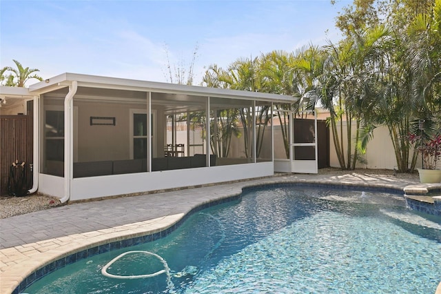 view of swimming pool featuring a sunroom