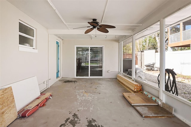 unfurnished sunroom with ceiling fan