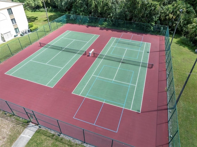 view of tennis court with a lawn