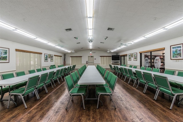 dining space featuring vaulted ceiling, dark hardwood / wood-style floors, and ceiling fan