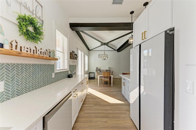 kitchen with pendant lighting, dishwasher, white cabinets, decorative backsplash, and light hardwood / wood-style flooring