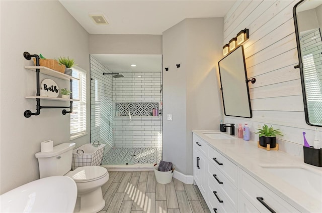 bathroom featuring vanity, toilet, and a shower with door