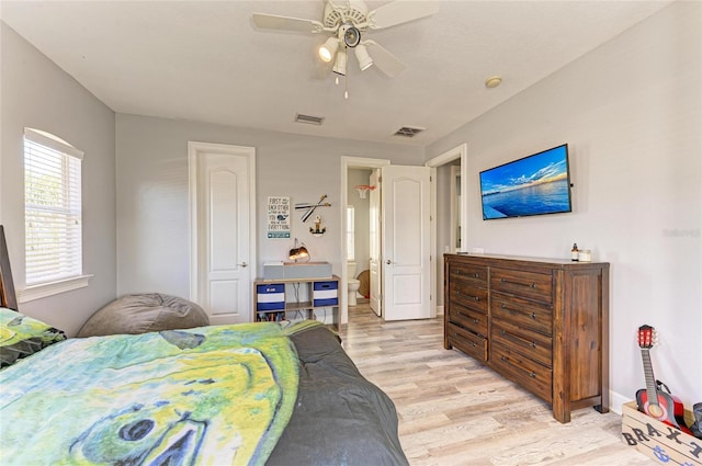 bedroom featuring connected bathroom, ceiling fan, and light wood-type flooring