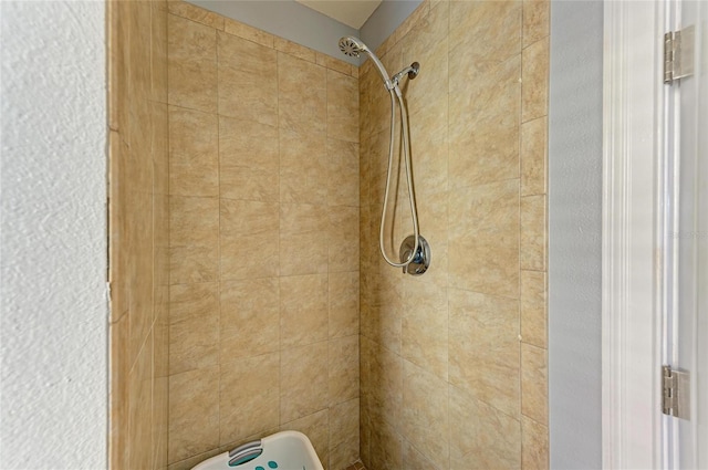 interior details with a tile shower