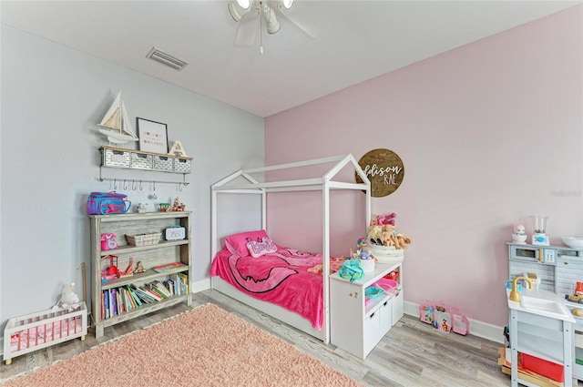 bedroom with hardwood / wood-style floors and ceiling fan