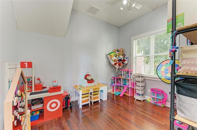 playroom with dark hardwood / wood-style floors and ceiling fan