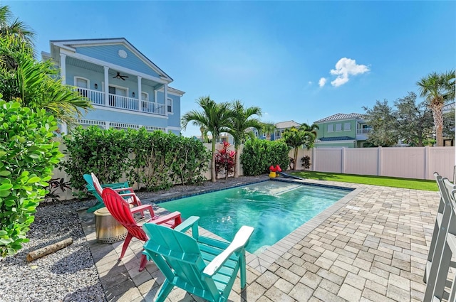 view of pool with a patio area and ceiling fan