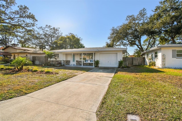 ranch-style house with a garage, covered porch, and a front lawn