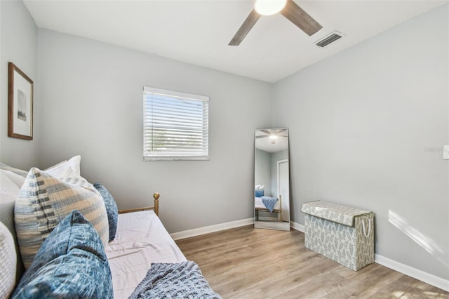 bedroom with light hardwood / wood-style flooring and ceiling fan