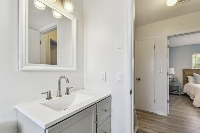 bathroom with vanity and hardwood / wood-style floors