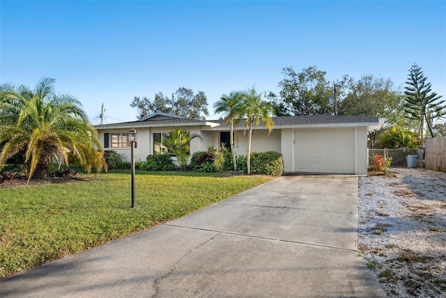 ranch-style house featuring a garage and a front yard