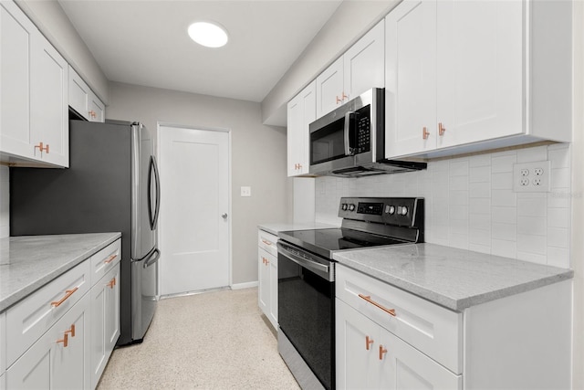 kitchen featuring white cabinetry, stainless steel appliances, light stone countertops, and backsplash