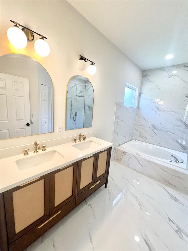 bathroom featuring independent shower and bath and vanity