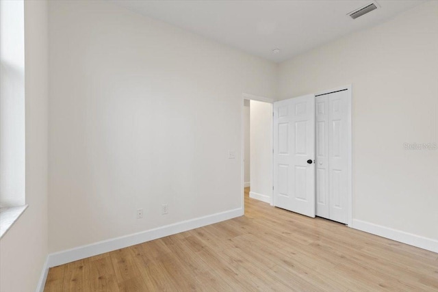 empty room with light hardwood / wood-style flooring