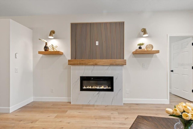 unfurnished living room with a fireplace and light hardwood / wood-style flooring