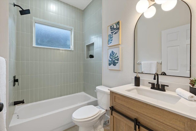 full bathroom with vanity, tiled shower / bath, and toilet