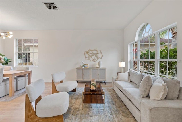 living room with a chandelier and light hardwood / wood-style floors