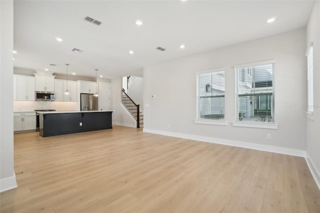 unfurnished living room featuring light hardwood / wood-style floors