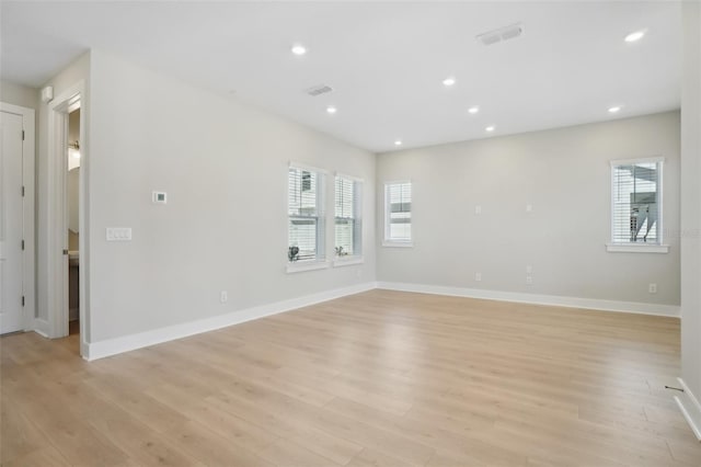 unfurnished room with light hardwood / wood-style floors and a healthy amount of sunlight