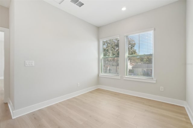 unfurnished room with light wood-type flooring