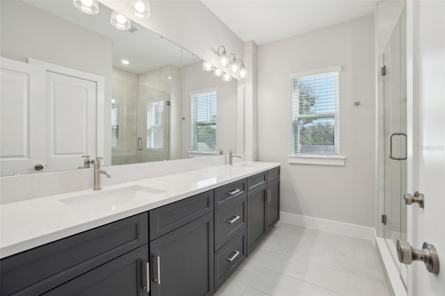 bathroom with tile patterned floors, an enclosed shower, and vanity