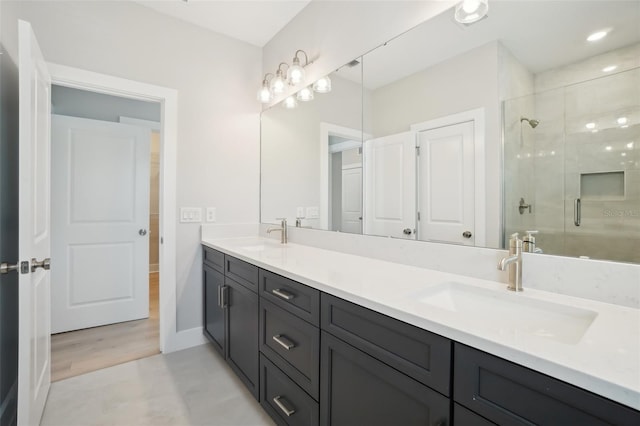 bathroom featuring vanity and a shower with shower door