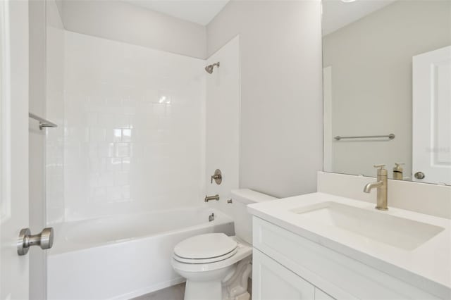 full bathroom featuring vanity, tiled shower / bath, and toilet