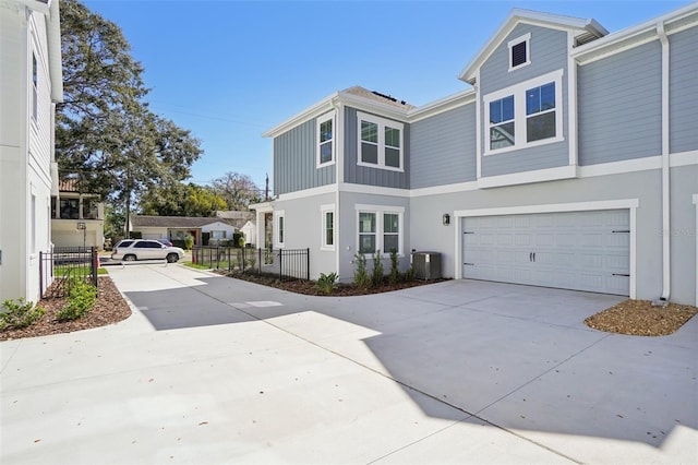 view of front of property featuring central AC unit and a garage