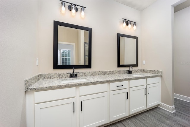 bathroom featuring vanity and hardwood / wood-style floors