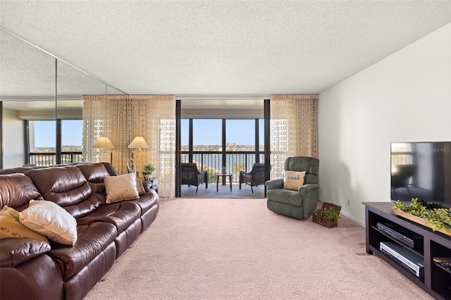 living room with floor to ceiling windows, a textured ceiling, and carpet flooring