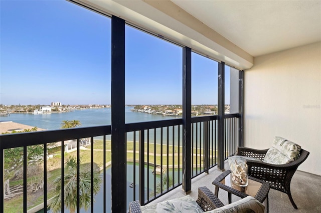 sunroom / solarium featuring a water view