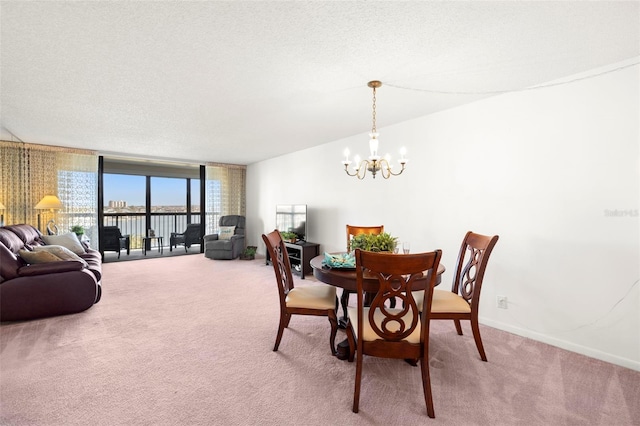 dining area with a wall of windows, carpet flooring, a textured ceiling, and a notable chandelier