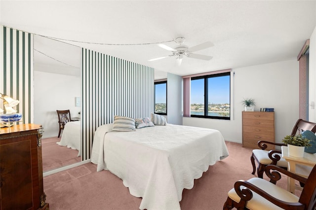 bedroom with ceiling fan and light carpet