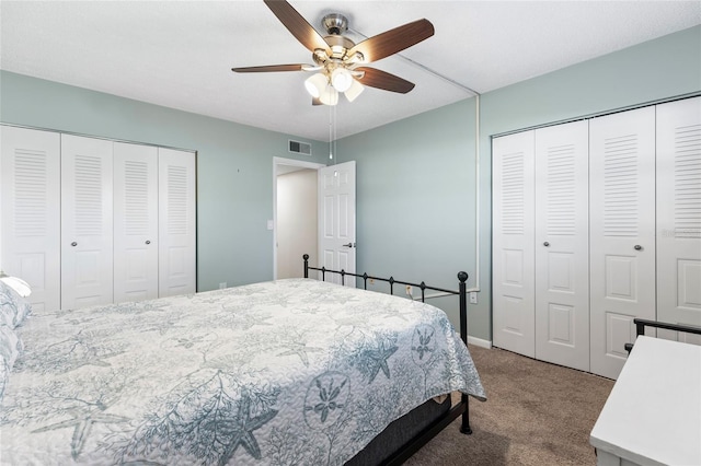 carpeted bedroom with multiple closets and ceiling fan