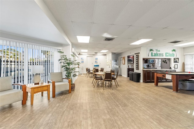 dining space with a paneled ceiling