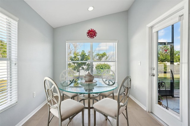 dining space with lofted ceiling and light hardwood / wood-style floors