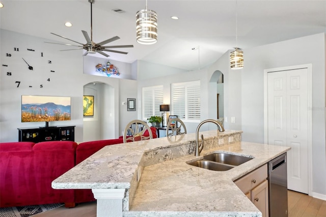 kitchen featuring dishwasher, pendant lighting, sink, and a center island with sink