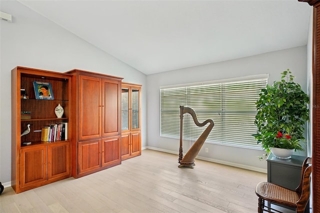 sitting room featuring lofted ceiling and light wood-type flooring